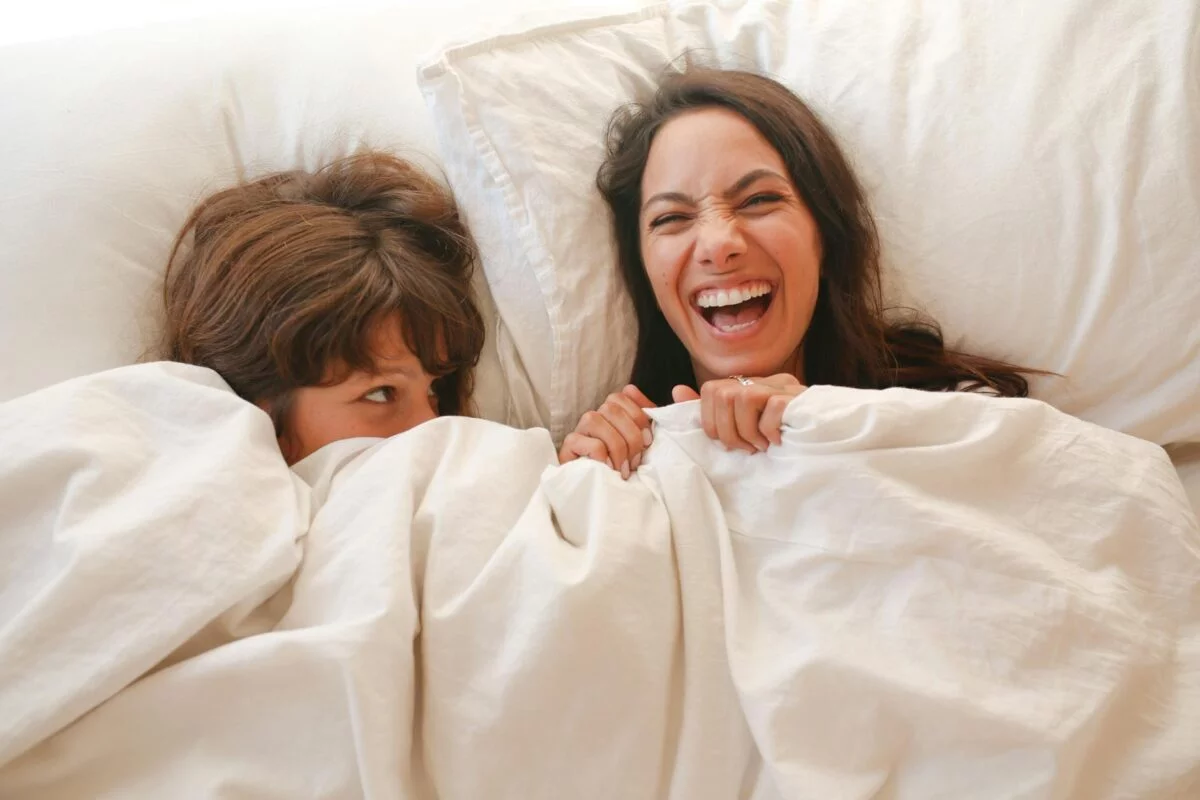 happy couple lying on bed