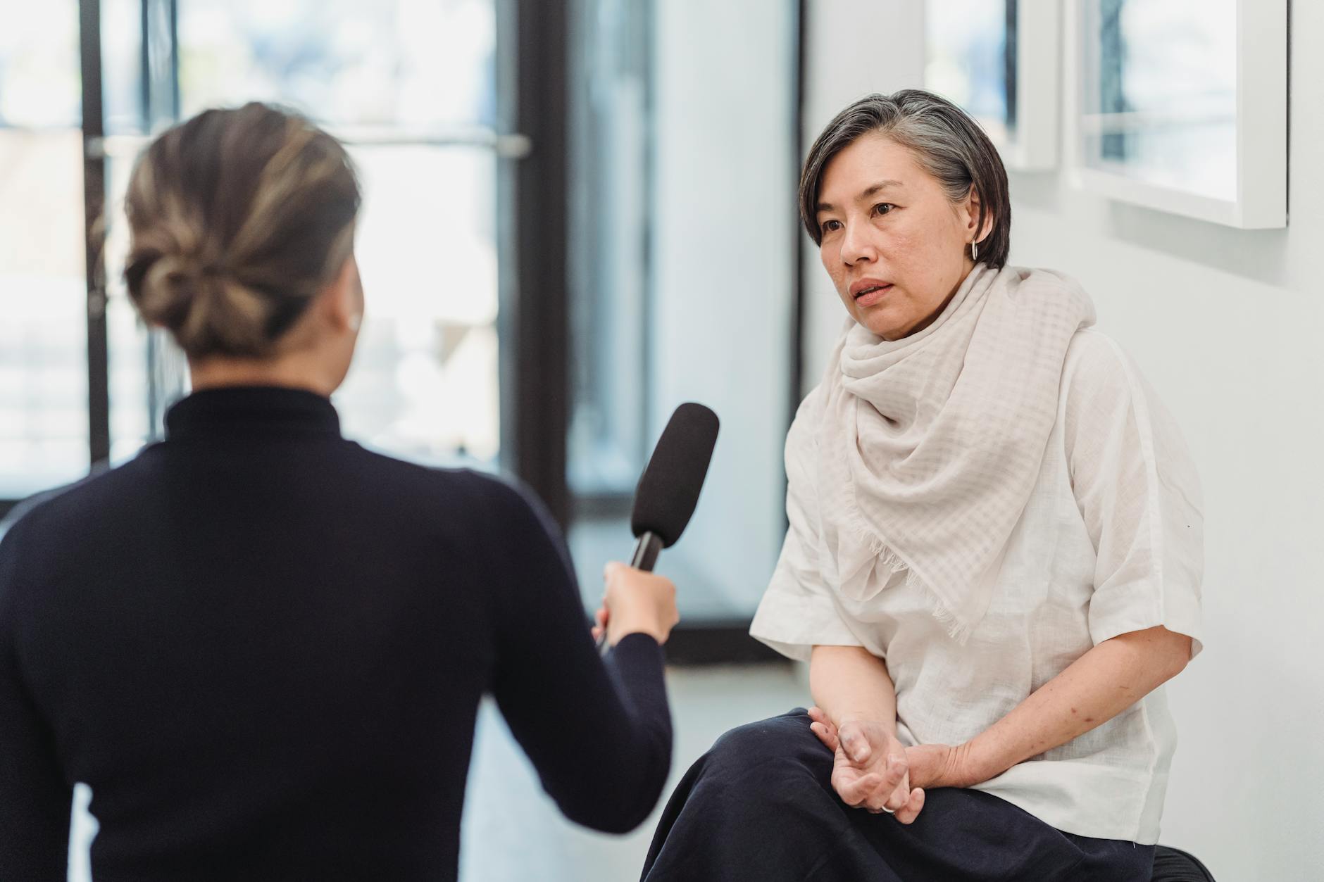 a woman being interviewed by a reporter